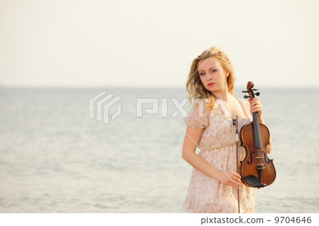 The blonde girl with a violin outdoor 9704646