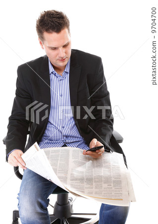 man reads newspaper phoning - economy news 9704700