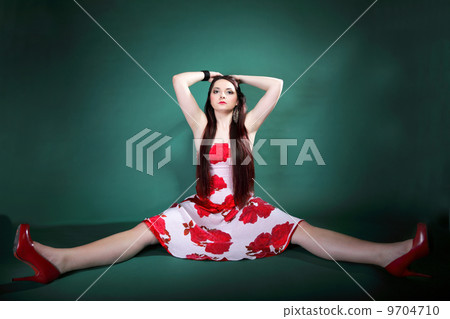 young woman in summer flowery dress on green 9704710