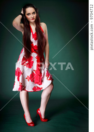 young woman in summer flowery dress on green 9704712