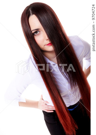 Woman covers part of face by straight long hair 9704724