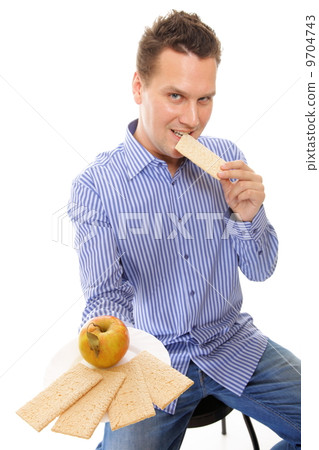 Healthy lifestyle man eating crispbread and apple 9704743