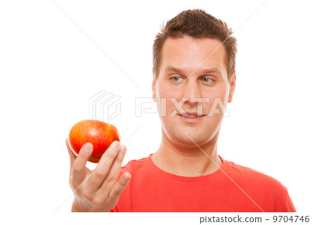 Happy man in red shirt holding apple. Diet health care healthy nutrition. 9704746