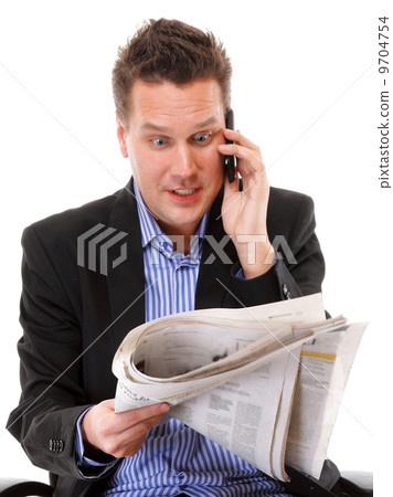 man looks surprised while reading a newspaper 9704754