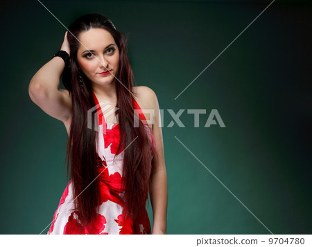 young woman in summer flowery dress on green 9704780
