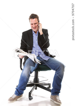 man reads newspaper phoning - economy news man reads newspaper phoning - economy news 9704787