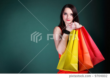 young woman with paper multi coloured shopping bag young woman with paper multi coloured shopping bag 9704802