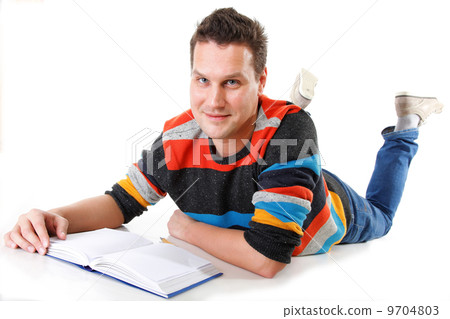 young man reading a book on the floor isolated 9704803
