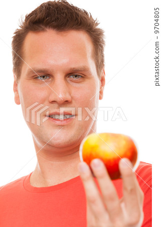 Happy man in red shirt holding apple. Diet health care healthy nutrition. 9704805