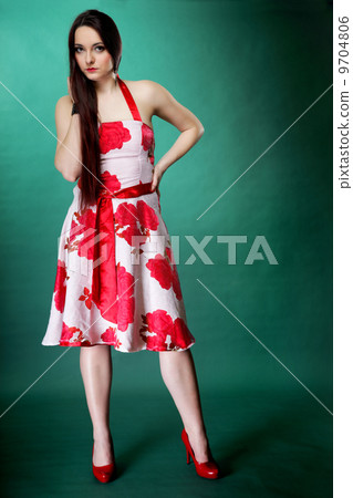 young woman in summer flowery dress on green 9704806