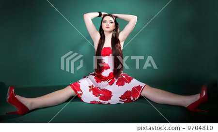 young woman in summer flowery dress on green 9704810