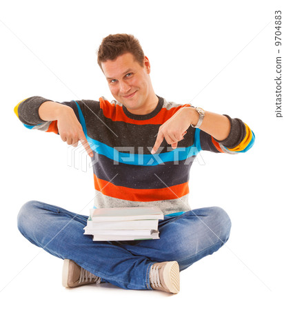 Man college student sitting and showing offering books isolated Man college student sitting and showing offering books isolated 9704883