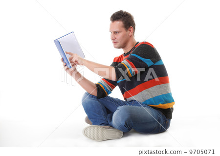 young man reading a book on the floor isolated 9705071