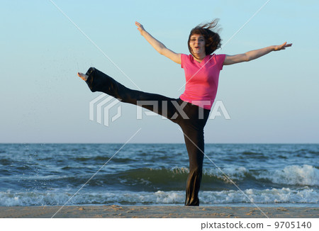 Exercising on the beach at sunset 9705140
