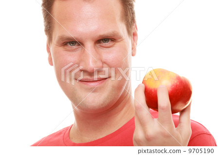Happy man in red shirt holding apple. Diet health care healthy nutrition. 9705190