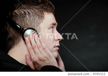 young man with headphones listening to music 9705311