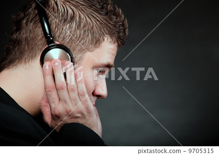 young man with headphones listening to music 9705315