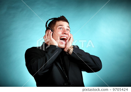 young man with headphones listening to music young man with headphones listening to music 9705424