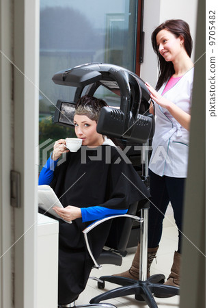 Woman drinking coffee tea in hair beauty salon. By hairdresser. 9705482