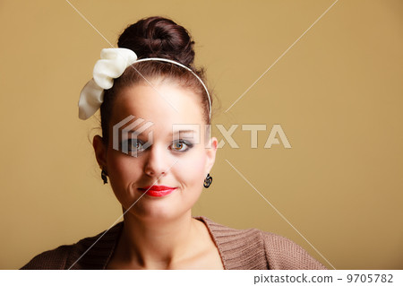 Portrait young beautiful girl retro style make-up and hair bun Portrait young beautiful girl retro style make-up and hair bun 9705782