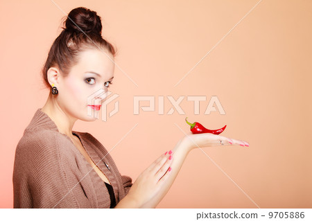 Beautiful woman fashion girl with red lips and chilli pepper Beautiful woman fashion girl with red lips and chilli pepper 9705886