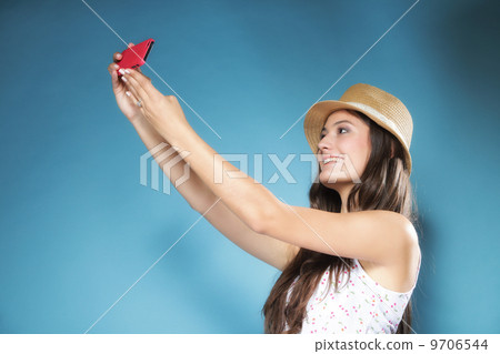 Girl with mobile phone taking photo of herself 9706544