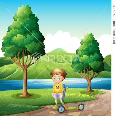A young boy with a scooter standing near the river A young boy with a scooter standing near the river 9707258