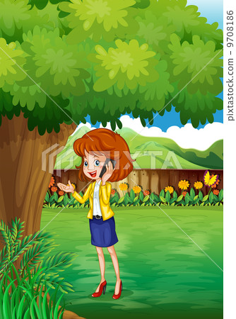 A woman with a cellphone standing under the tree A woman with a cellphone standing under the tree 9708186