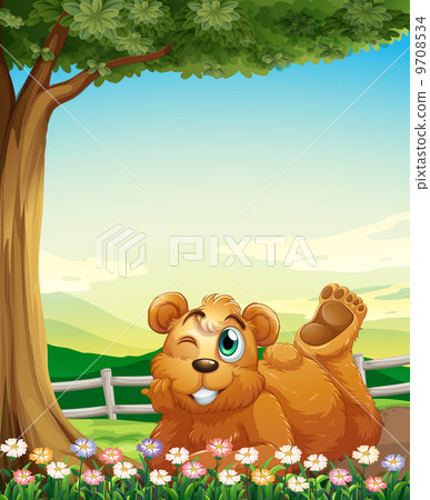 A bear under the tree near the flowers A bear under the tree near the flowers 9708534