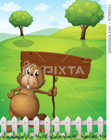 A beaver holding an empty signboard standing near the fence 9708912