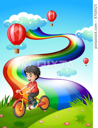 A boy biking at the hilltop with a rainbow 9708925