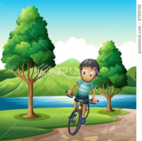 A male biker biking near the river A male biker biking near the river 9709588