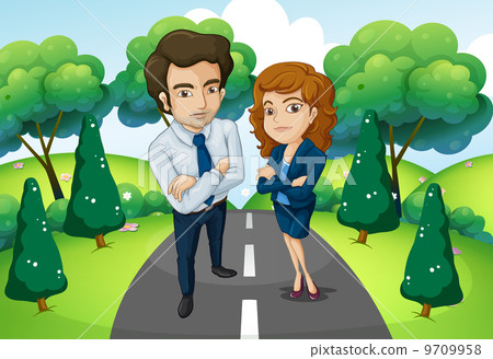 A male and a female standing in the middle of the road A male and a female standing in the middle of the road 9709958