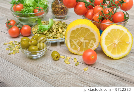 lemon, olives and other food on a wooden table lemon, olives and other food on a wooden table 9712283