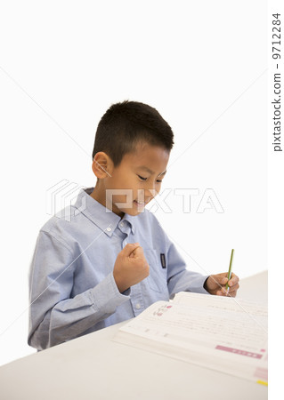 A boy studying 9712284