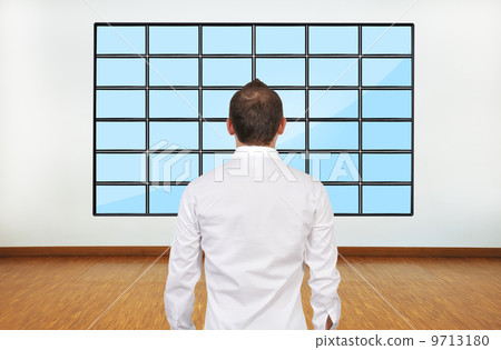 businessman looking on plasma businessman looking on plasma 9713180