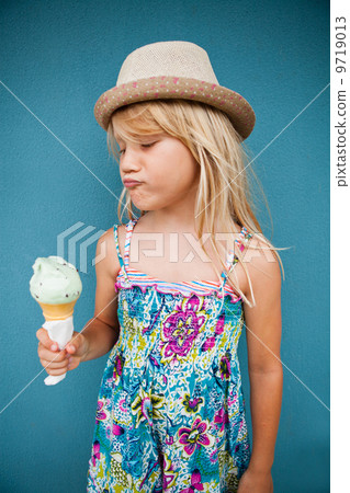 Young girl holding ice cream cone 9719013
