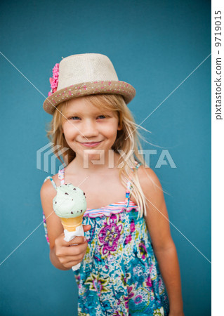 Young girl holding ice cream cone Young girl holding ice cream cone 9719015