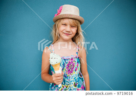 Young girl holding ice cream cone Young girl holding ice cream cone 9719016