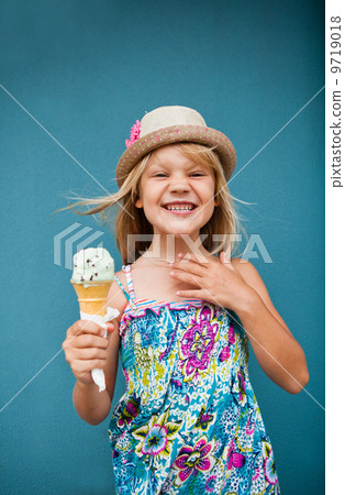 Young girl holding ice cream cone Young girl holding ice cream cone 9719018