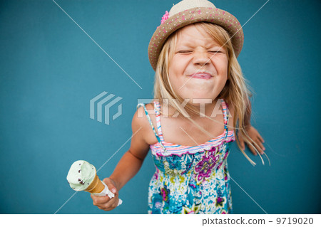 Young girl holding ice cream cone Young girl holding ice cream cone 9719020