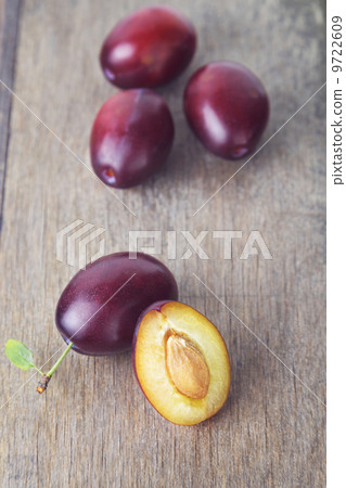 ripe plums on old wood table 9722609