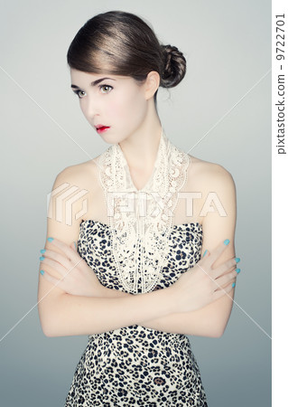 Portrait of young woman in a leopard print dress. 9722701