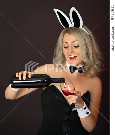 Playful girl at the party pours wine Playful girl at the party pours wine 9723633