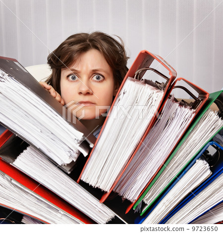 Accountant swamped with financial documents 9723650