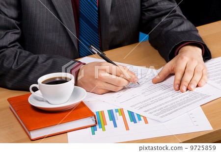 Businessman's table covered with documents Businessman's table covered with documents 9725859