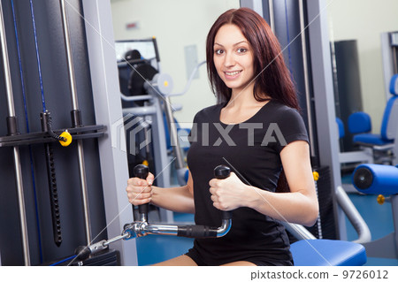 Beautiful slim woman training in a gym 9726012