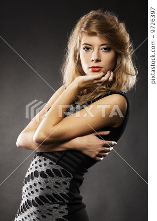 Portrait of beautiful tranquil model, black background 9726397