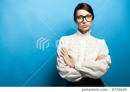 Strict woman in large glasses 9726680