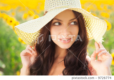Beautiful lady walking in sunflower field Beautiful lady walking in sunflower field 9726774